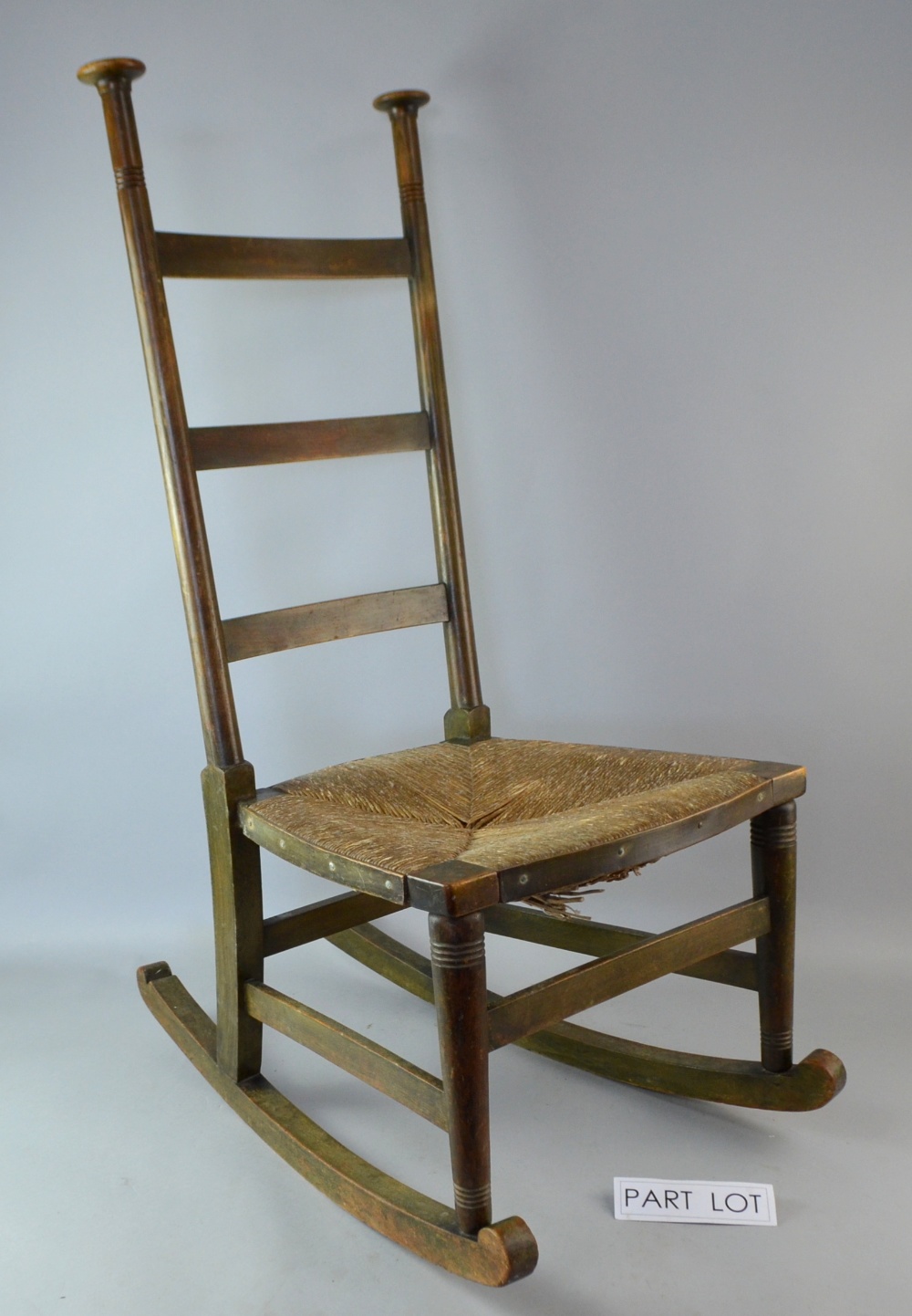 Voysey chair with rush seat and fixed Liberty's label and another chair..