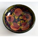 Moorcroft pottery, a Pomegranate shallow bowl on small reeded foot, stamped, and marked in blue on