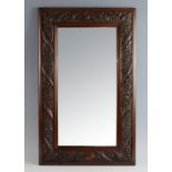 Arts & Crafts mahogany wall mirror, the frame heavily carved with Acanthus leaves, frame size 50 x