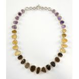 Silver fringe necklace made up of amethyst, citrine and smoky quartz irregular forms in handmade