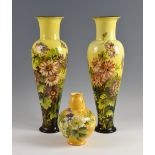 A pair of 19th century Doulton Lambeth faience vases in yellow ground with floral decoration,