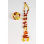An amber pendant necklace, with inverted heart and abstract forms, and a triangular section bracelet