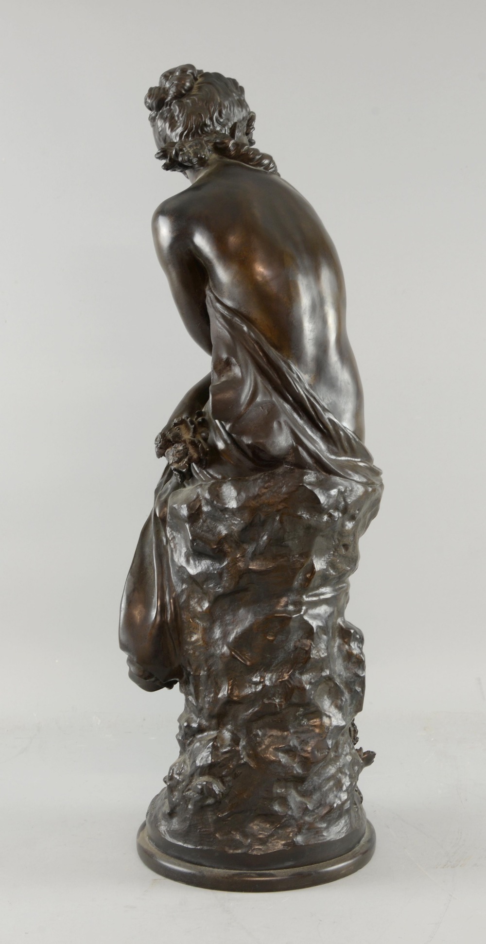 After Auguste Moreau, bronze figure of a semi clad maiden seated and holding flowers, signed in the - Image 2 of 2
