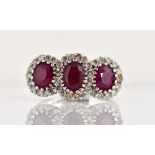 Ruby and diamond triple cluster ring, three oval cut rubies surrounded by round brilliant cut