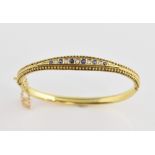Victorian oval hinged bangle, with five old cut diamonds, alternately set with six round cut