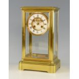 French brass and four glass mantel clock, twin train with visible escapement, striking on a bell,