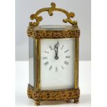Early 20th century brass and glass carriage clock , 16cm high .