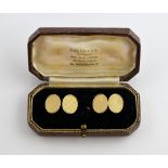 A pair of 1950's gold cufflinks, oval engine turned panels, with chain link attachment, in 9ct