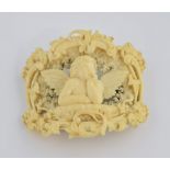 19th C Dieppe ivory brooch, central Cherub in a border of foliage and grape vines, measuring