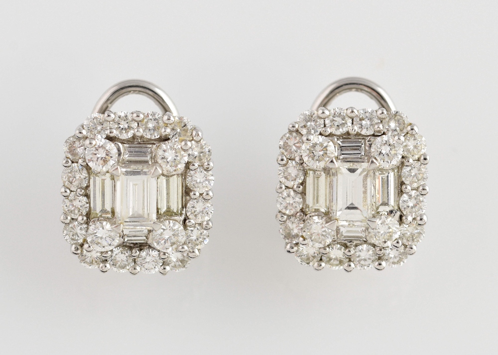 A pair of diamond cluster earrings, with central baguette cut stones with brilliant cut stone