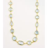 Spectacle set aquamarine necklace, with mixture of gemstone cuts, joined by chain links, mounted