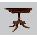 Regency mahogany card table, on turned central column, quatrefoil supports, brass feet and