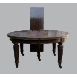 19th century mahogany circular dining table on turned reeded tapering legs and casters 148cm