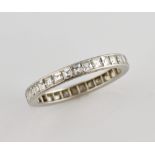 Diamond eternity and platinum band ring set with square step cut diamonds, in unmarked metal testing
