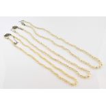 Three cultured pearl necklaces, graduated pearls, strung with knots, one with white metal sapphire