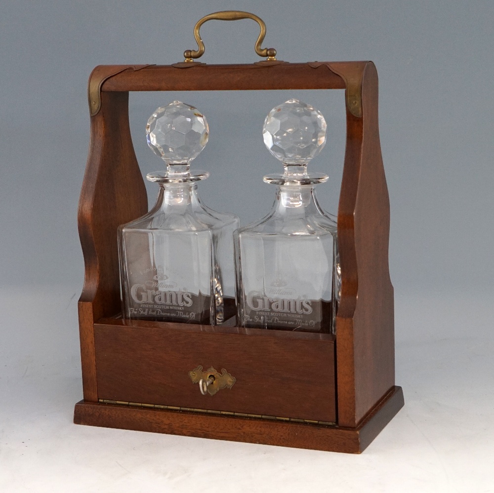 20th century mahogany two bottle tantaluses, 26cm wide .