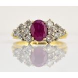 Ruby and diamond dress ring, central oval cut ruby, set with twelve round brilliant cut diamonds,