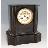 19th century black slate mantle clock the two train movement striking on a bell, 28cm high.