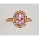 Pink morganite set ring, with central stone oval stone of 1.76 carats within a band of diamonds, and