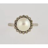 Pearl and diamond ring, centrally set white round pearl measuring 8.5mm, within a border of Swiss