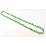 Graduated jade bead necklace, round beads measuring from 9 to 6 mm, strung with knots, measuring