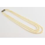 Three strand cultured pearl necklace, pearls graduating in size from 3.5 to 7.5 cm, strung to a