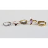 Five gem set rings, channel set diamond ring, another set with tanzanite, amethyst marquise ring,