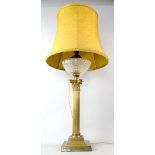 Brass Corinthian column oil lamp with cut glass reservoir, now converted to electricity, 60cm high.