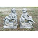 Pair of composite stone cherubs resting on C scrolls, 72cm high