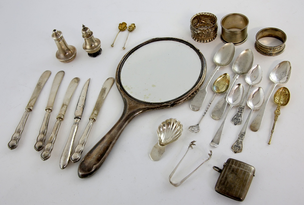 Selection of silver flatware including teaspoons, vesta, hand mirror, napkin rings and other items,.