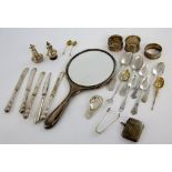 Selection of silver flatware including teaspoons, vesta, hand mirror, napkin rings and other items,.