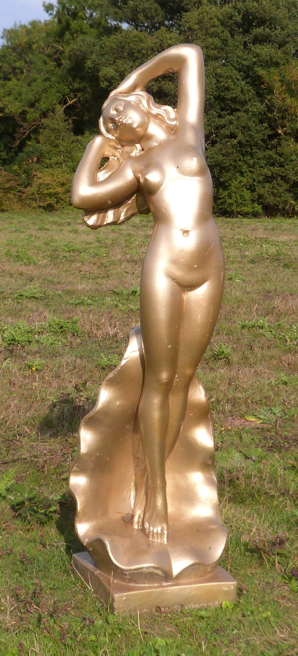 Modern concrete gold painted figure of a woman standing in a shell, 108cm high,