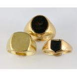 Three signet rings, oval blood stone intaglio of a wading bird, mounted in yellow metal stamped 18