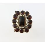 Georgian garnet and seed pearl ring, rectangular cabochon cut garnet surrounded by a border of