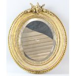 19th century oval gilt wood wall mirror with foliate cresting, 46cm