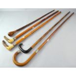 Collection of walking canes 2 with horn handles and 2 with silver collars (5).