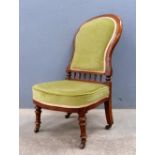 Two Victorian walnut spoon back chairs, upholstered in green chenille on turned legs