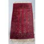 Red ground Afghan type rug 185 x 80 cm