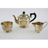 George VI silver three piece round ea service of plain form the teapot with ebonised knob and