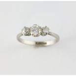 Diamond three stone platinum ring, central transitional cut, set in-between two old cut diamonds,