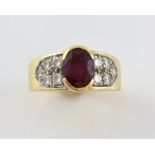 Vintage ruby and diamond dress ring, central oval cut ruby, with diamond set shoulders, ruby