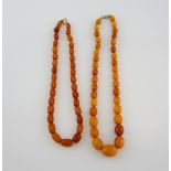 Graduated amber bead necklace, oval beads, measuring approximately 44.5cm, and facetted copal bead