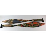 Two tribal wooden paddles, decorated with tropical birds, bears and sea creatures, 104 cm long (2).