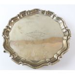 Silver presentation Salver with shaped pie crust border on three scroll feet, Sheffield 1922