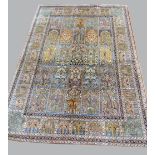 Persian peach ground silk carpet, the centre with repeating rectangular medallions, 275cm x 180cm