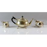 George V silver three piece tea service, comprising tea pot, cream jug and sugar bowl, with