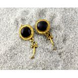 A pair of Roman/ Byzantine period gold and garnet earrings, cabochon stones in circular setting with