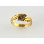 Edwardian sapphire and pearl twist ring, central pearl set in-between two round cut sapphires,