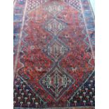 Blue ground Persian type rug, with central lozenge shaped medallions 300 x 217 cm