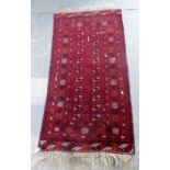 Persian type red ground rug the centre with repeating medallions 160 x 90 cm